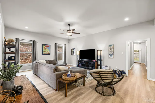 a living room with furniture and a flat screen tv