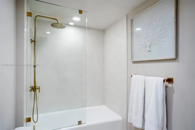 a bathroom with a shower and a bath tub