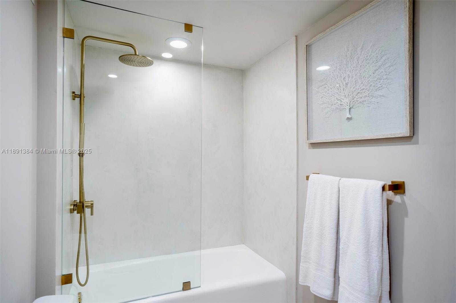 2301 Collins Avenue, Unit 836 Miami Beach, FL 33139 - Photo 12 of 29 a bathroom with a shower and a bath tub