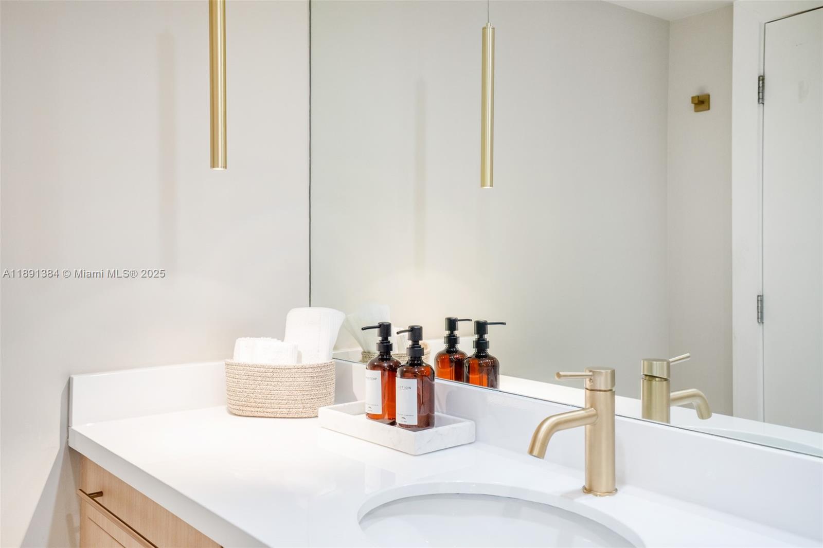 2301 Collins Avenue, Unit 836 Miami Beach, FL 33139 - Photo 13 of 29 a bathroom with a sink and a mirror