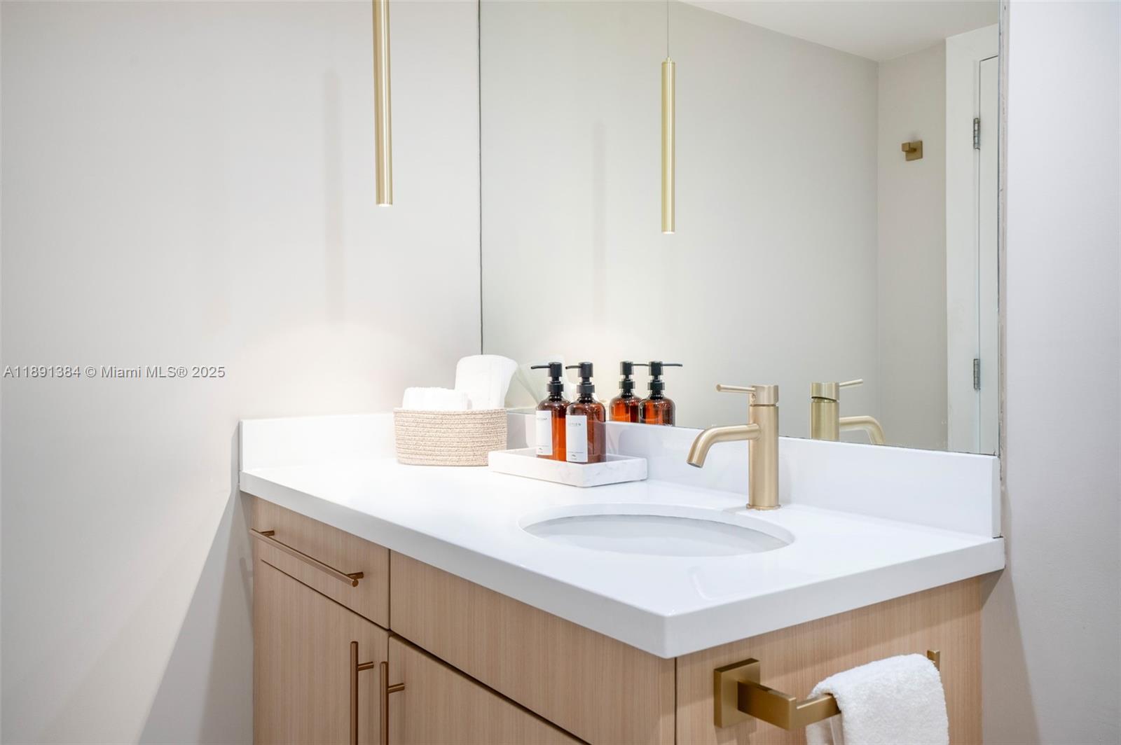 2301 Collins Avenue, Unit 836 Miami Beach, FL 33139 - Photo 14 of 29 a bathroom with a sink and a mirror