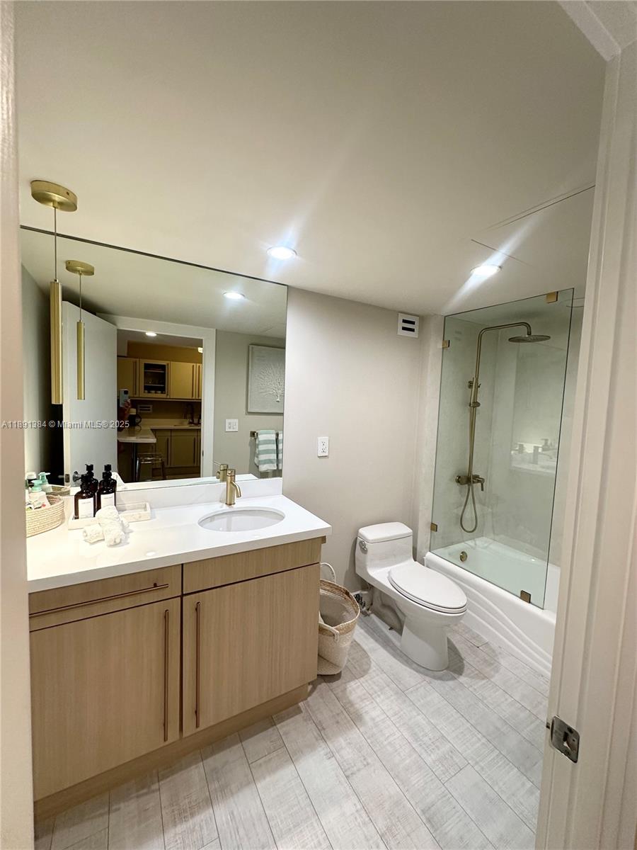 2301 Collins Avenue, Unit 836 Miami Beach, FL 33139 - Photo 16 of 29 a bathroom with a double vanity sink mirror and toilet