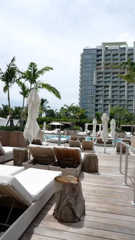a view of roof deck with couches and potted plants