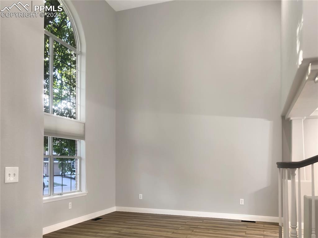 7873 Sweet Water Road Lone Tree, CO 80124 - Photo 11 of 48 an empty room with wooden floor and windows
