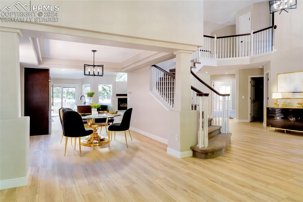 7873 Sweet Water Road Lone Tree, CO 80124 - Photo 12 of 48 a view of a dining room with furniture a chandelier and wooden floor