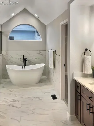 a spacious bathroom with a sink and a mirror
