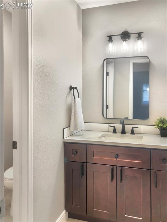 7873 Sweet Water Road Lone Tree, CO 80124 - Photo 20 of 48 a bathroom with a double vanity sink and a mirror