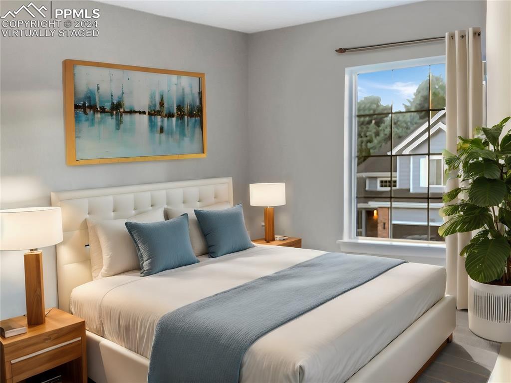 7873 Sweet Water Road Lone Tree, CO 80124 - Photo 28 of 48 a bedroom with a bed and a painting on the wall