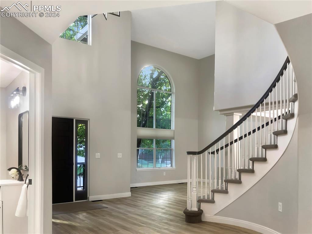 7873 Sweet Water Road Lone Tree, CO 80124 - Photo 9 of 48 a view of entryway with wooden floor and stairs