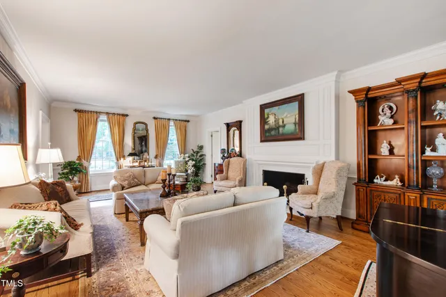 a bed sitting in a spacious bedroom next to a window