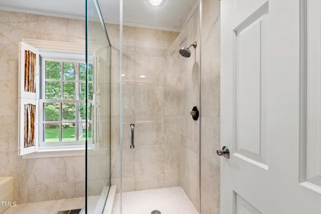 a bedroom with a bed chair and window