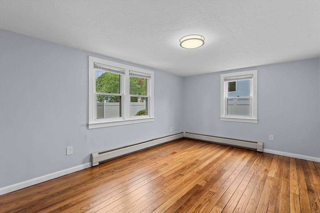 5 Phoenix Street Worcester, MA 01604 - Photo 25 of 32 a view of an empty room with wooden floor and a window