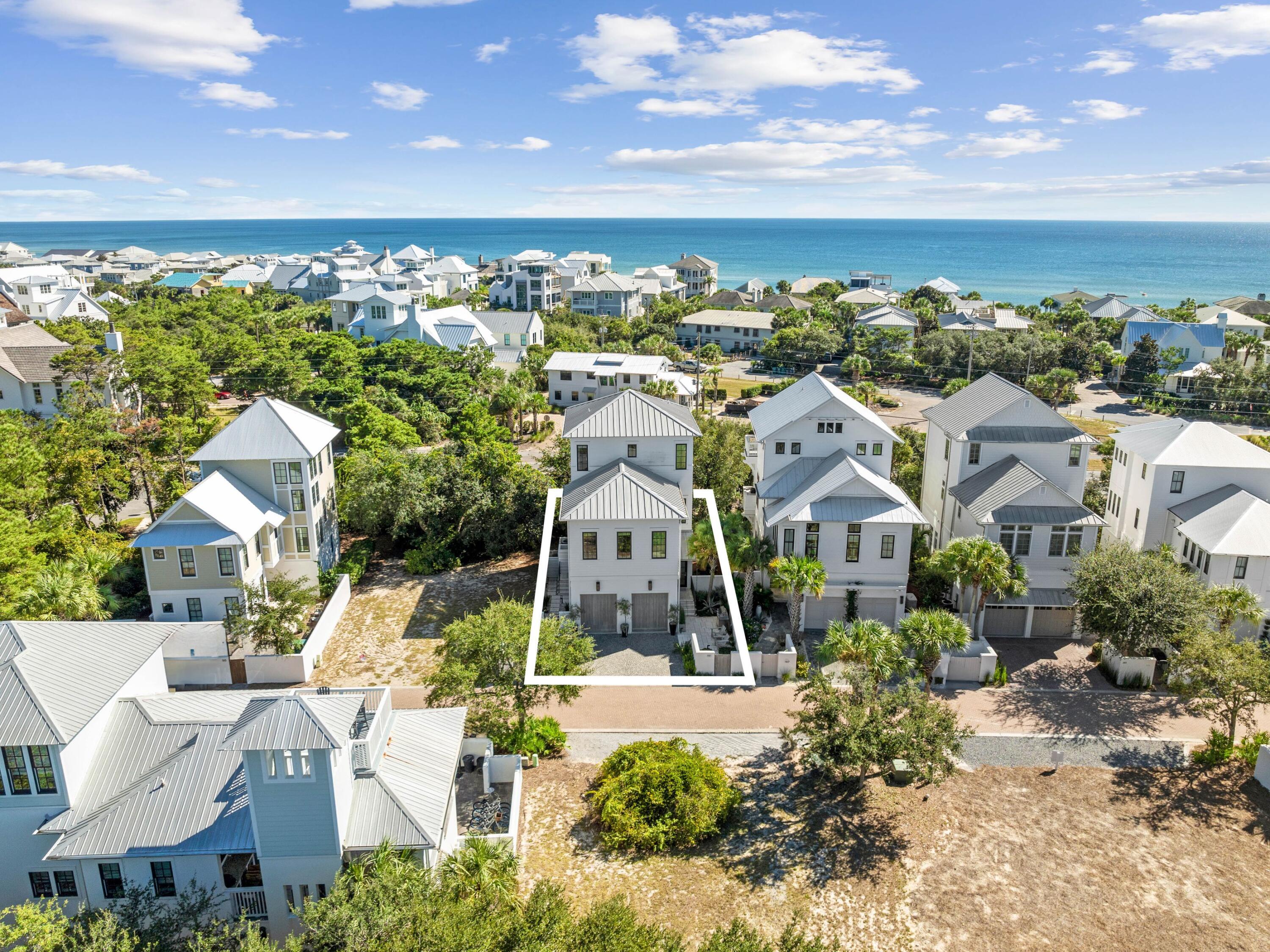 a view of a city with lots of residential buildings ocean and mountain view in back