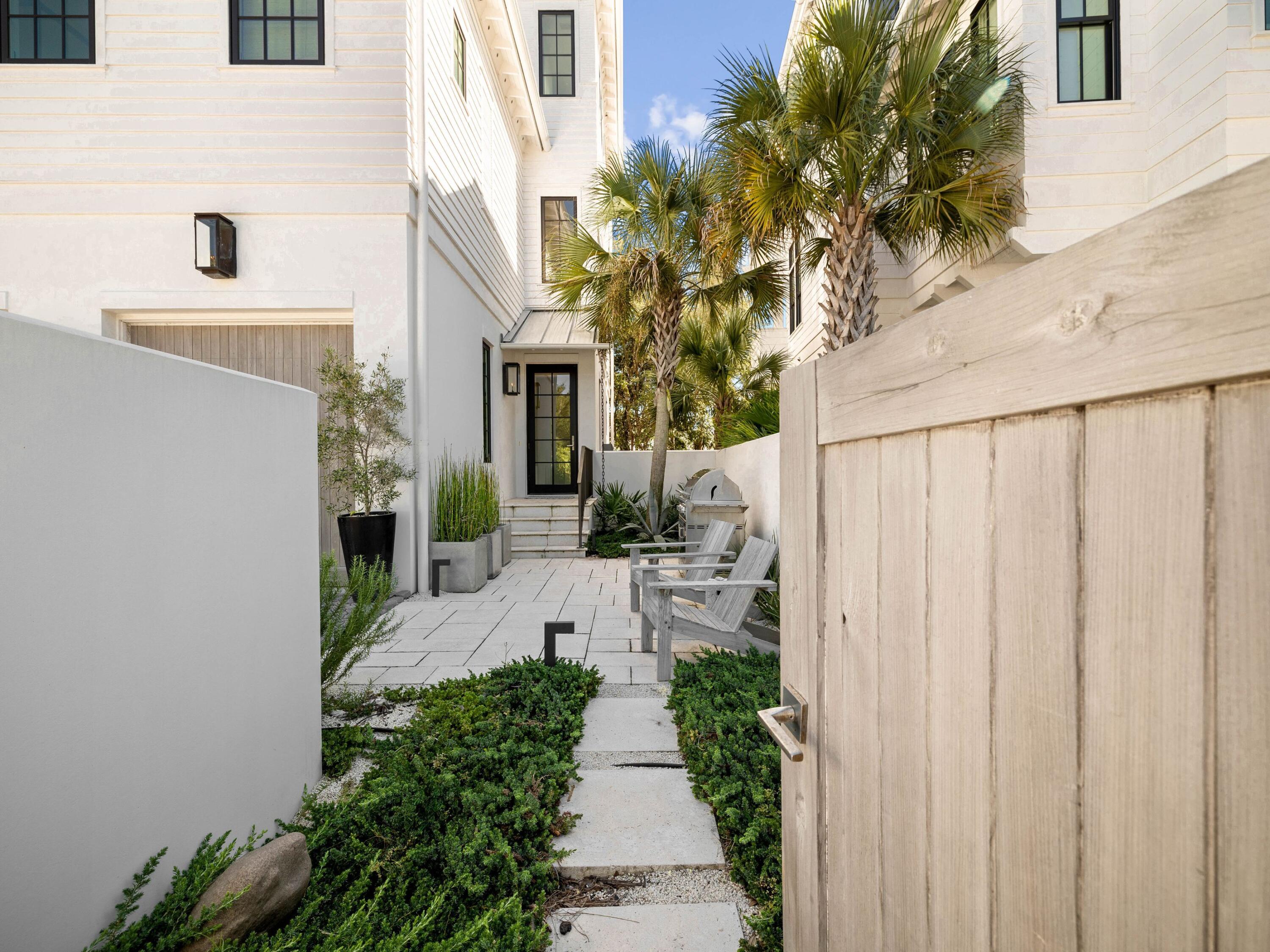 191 Sand Oaks Circle Santa Rosa Beach, FL 32459 - Photo 5 of 47 a view of a pathway with house with flower plants