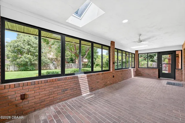a kitchen with stainless steel appliances granite countertop white cabinets and a window