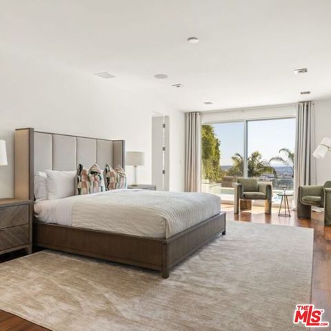 a bedroom with a large bed and a large window