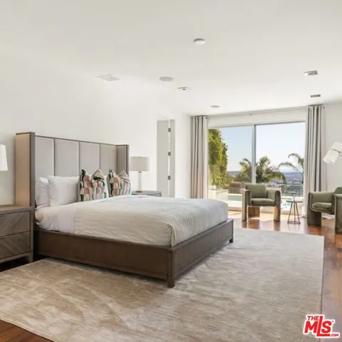 a bedroom with a large bed and a large window