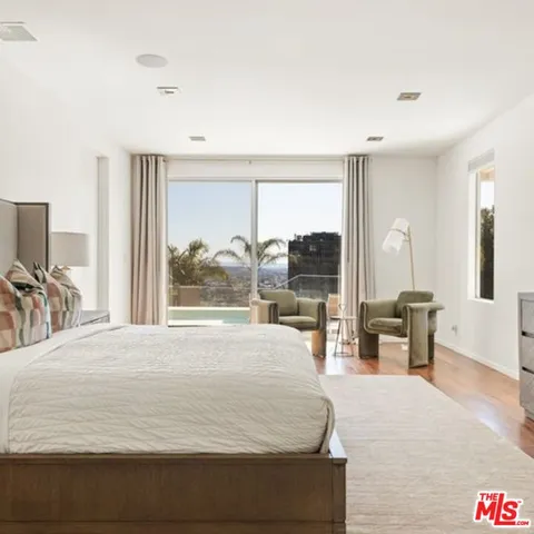 a large bed sitting in a bedroom and a table