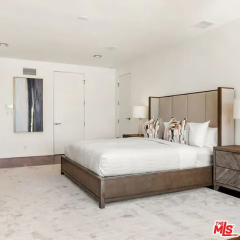 a bathroom with a tub a sink and glass door
