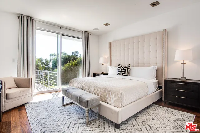 a bedroom with a large bed and a large window