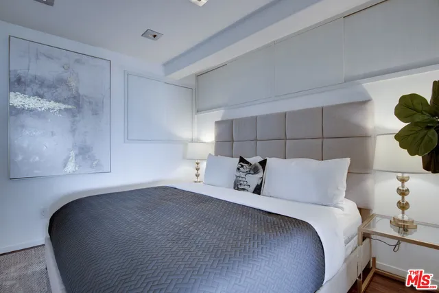 a bedroom with furniture and a flat screen tv