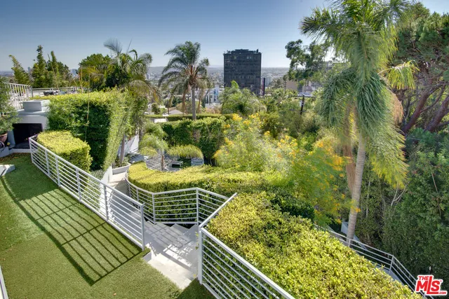 a view of a house with swimming pool and furniture