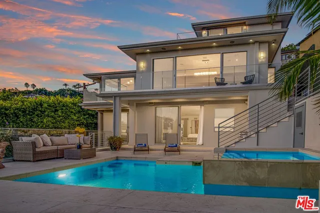 a view of a patio with furniture and a garden