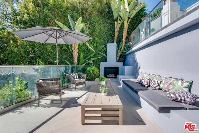 a view of an house with backyard and furniture