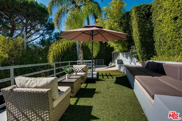 a view of a roof deck with couches and potted plants