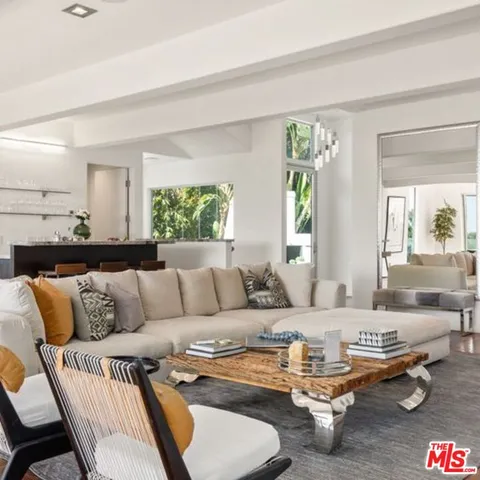 a view of a city from a balcony with furniture