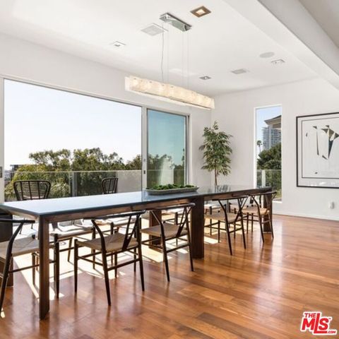 a kitchen with kitchen island stainless steel appliances a sink stove and refrigerator