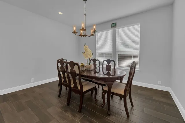 a view of a dining room with furniture wooden floor and chandelier