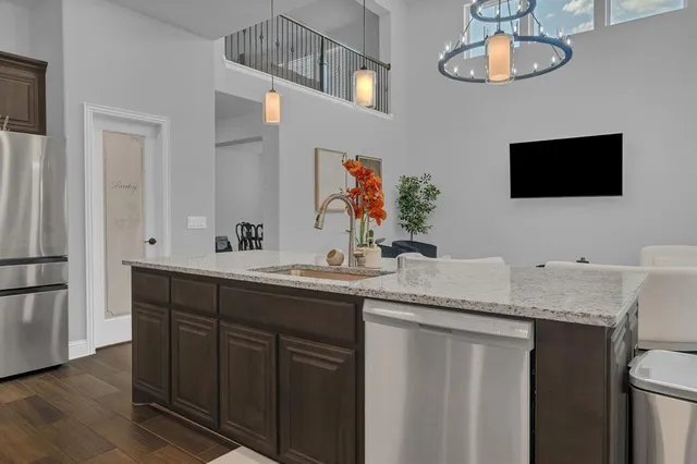 a bathroom with a granite countertop double vanity and a mirror