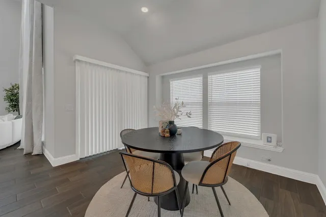 a view of a dining room with furniture and wooden floor