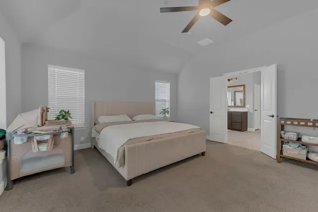 a spacious bedroom with a bed and a couch