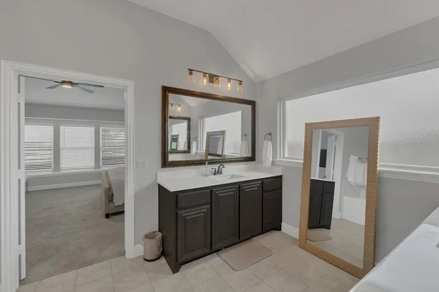 a bathroom with a double vanity sink and mirror