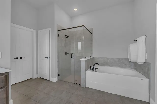 a bathroom with a bathtub and a shower