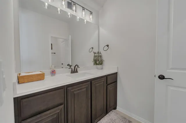 a bathroom with a sink a vanity and a mirror