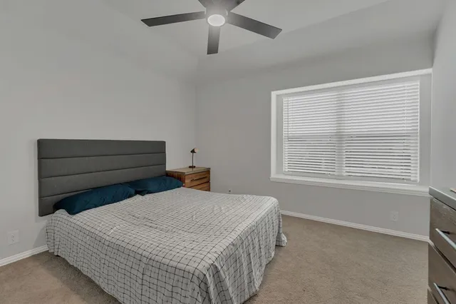 a bedroom with a bed and window