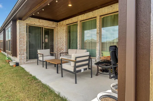 a balcony with furniture and a potted plant