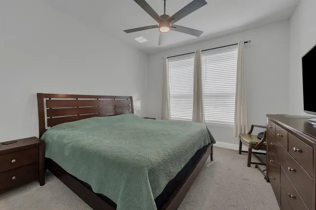 a bedroom with a bed and a tv