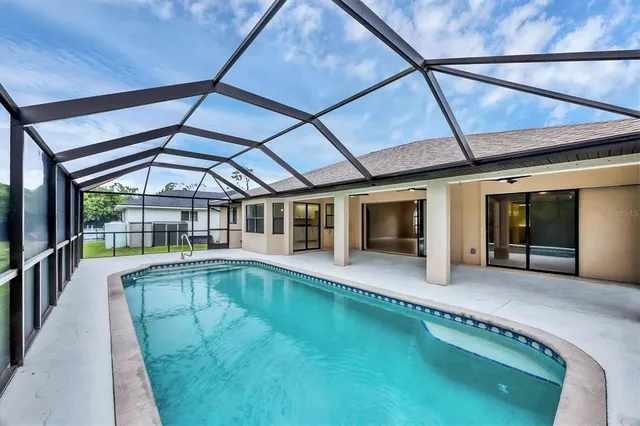 a view of a swimming pool with a yard