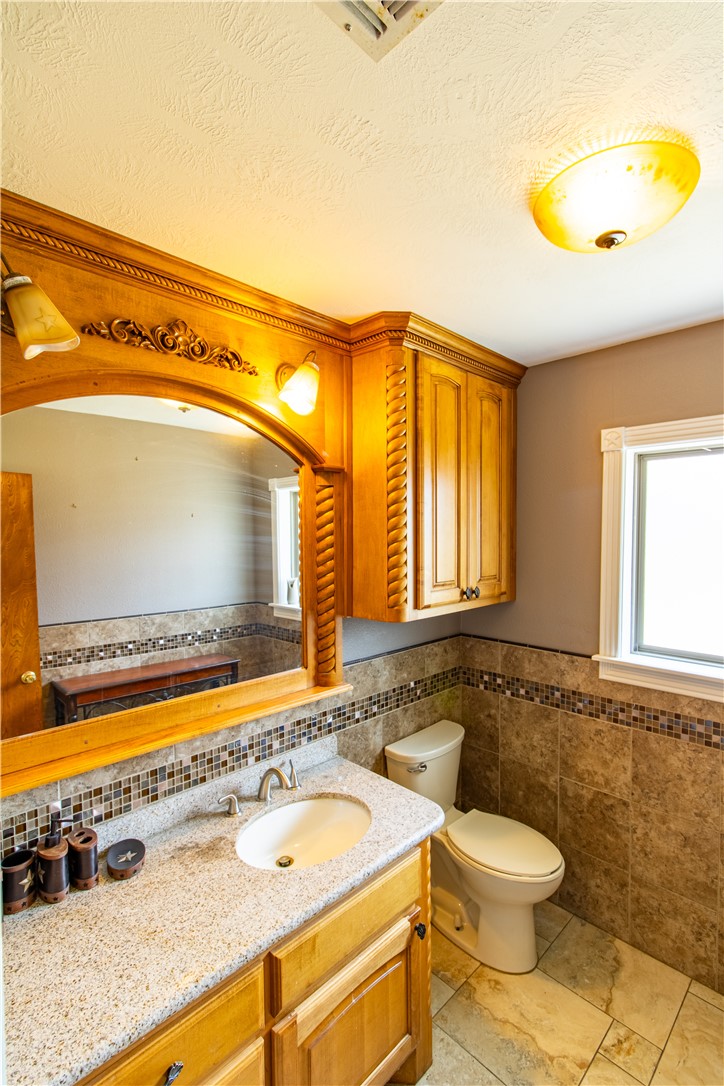 1214 Bittle Lane Bryan, TX 77801 - Photo 12 of 41 a bathroom with a granite countertop sink and a mirror