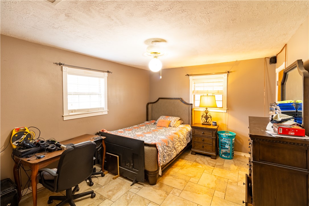 1214 Bittle Lane Bryan, TX 77801 - Photo 13 of 41 a bedroom with a bed and wooden floor