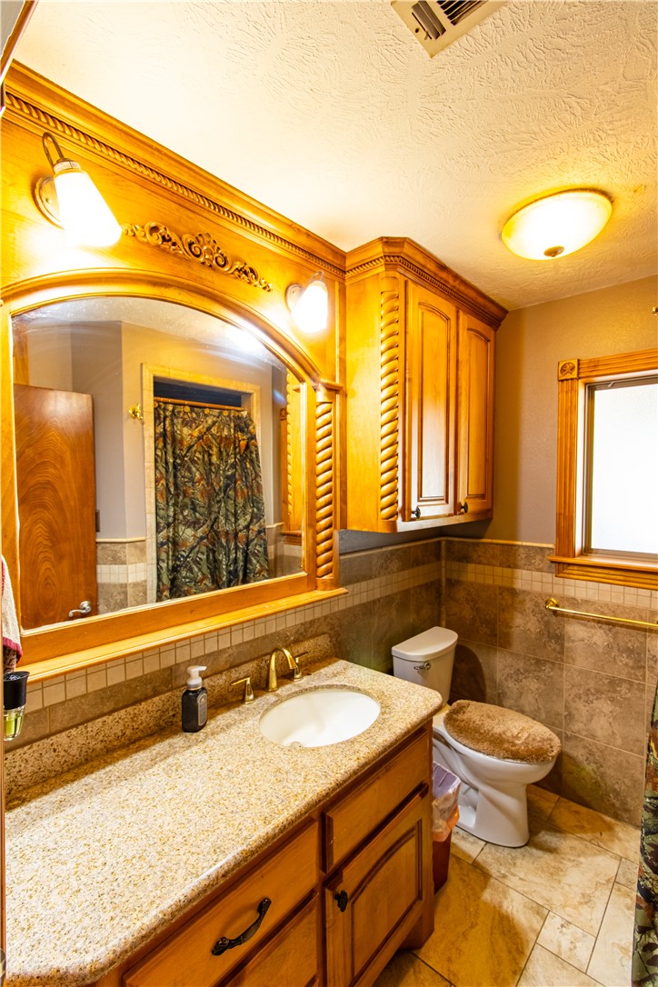 1214 Bittle Lane Bryan, TX 77801 - Photo 15 of 41 a bathroom with a granite countertop sink and a large mirror