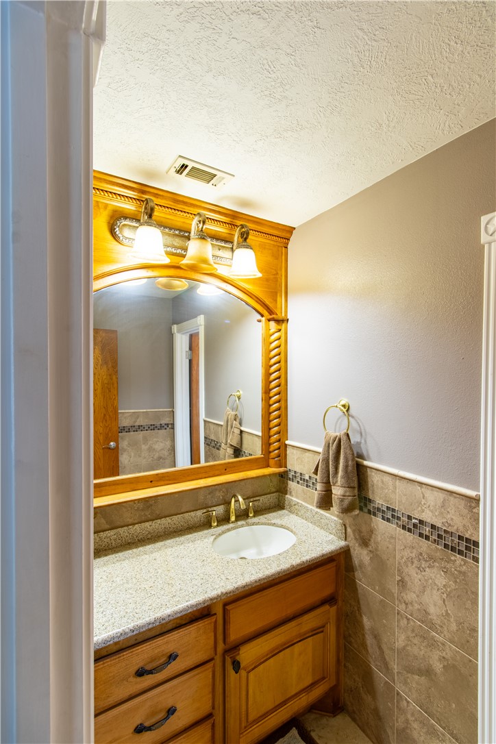 1214 Bittle Lane Bryan, TX 77801 - Photo 17 of 41 a bathroom with a granite countertop sink and a large mirror