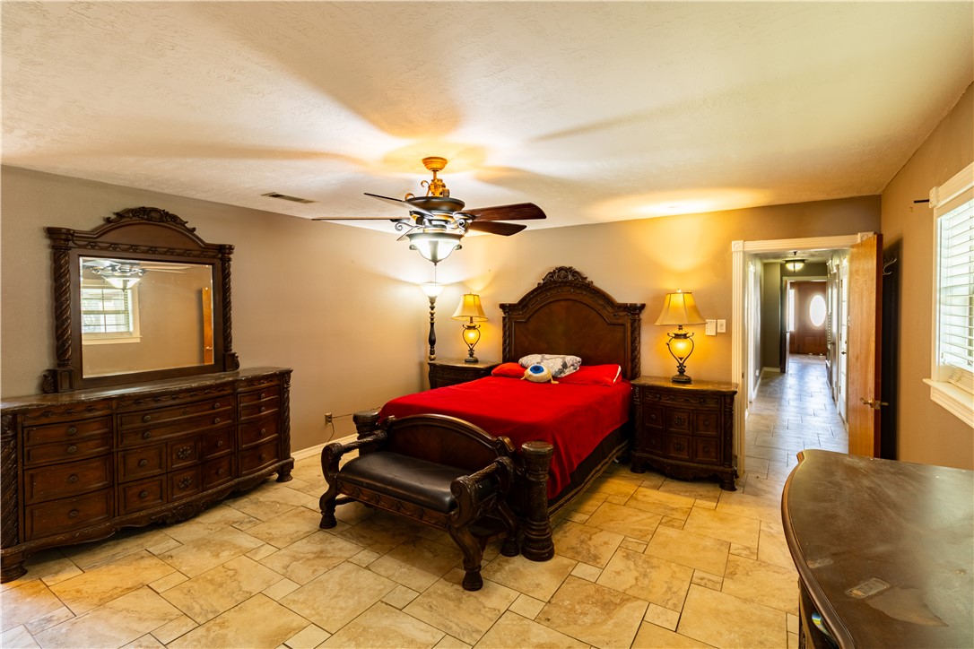 1214 Bittle Lane Bryan, TX 77801 - Photo 19 of 41 a bedroom with a bed and a chandelier
