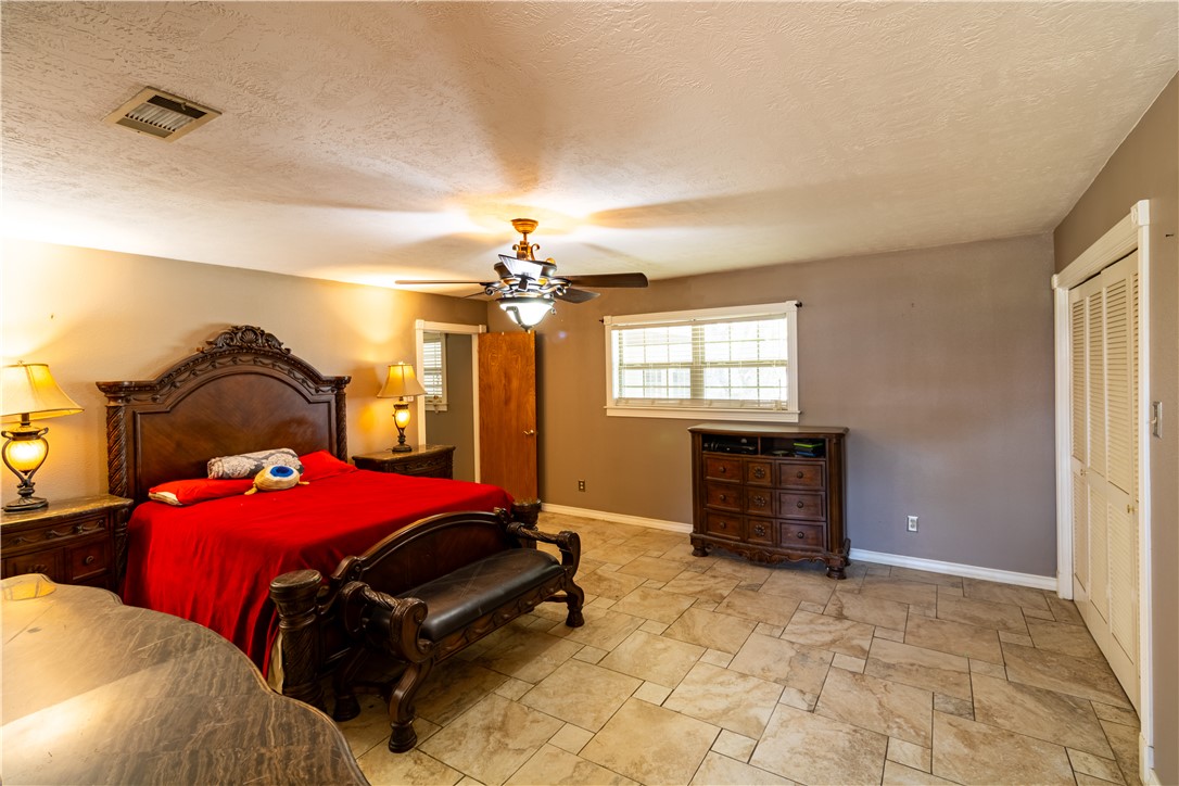 1214 Bittle Lane Bryan, TX 77801 - Photo 20 of 41 a bedroom with a bed and a chandelier