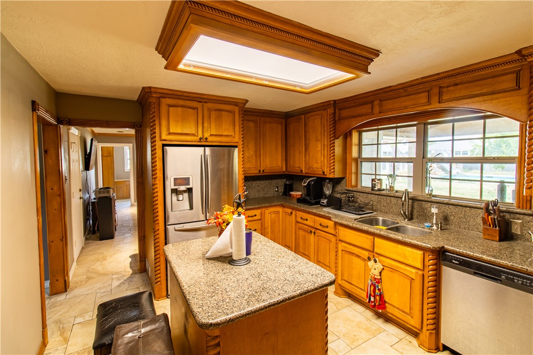 1214 Bittle Lane Bryan, TX 77801 - Photo 8 of 41 a kitchen with stainless steel appliances granite countertop sink stove and refrigerator