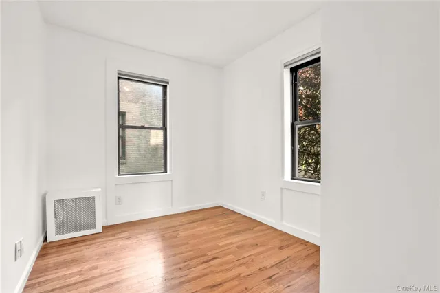 an empty room with windows and closet